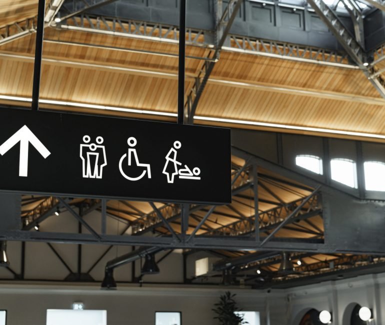 Modern public black toilet sign on the wall